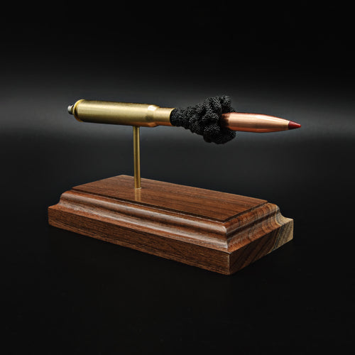 Front view of a .30-06 Springfield Hornady Precision Hunter 178gr ELD-X cartridge anatomy display showing the primer cup, anvil, cartridge case, simulated powder, and projectile on a hardwood base.