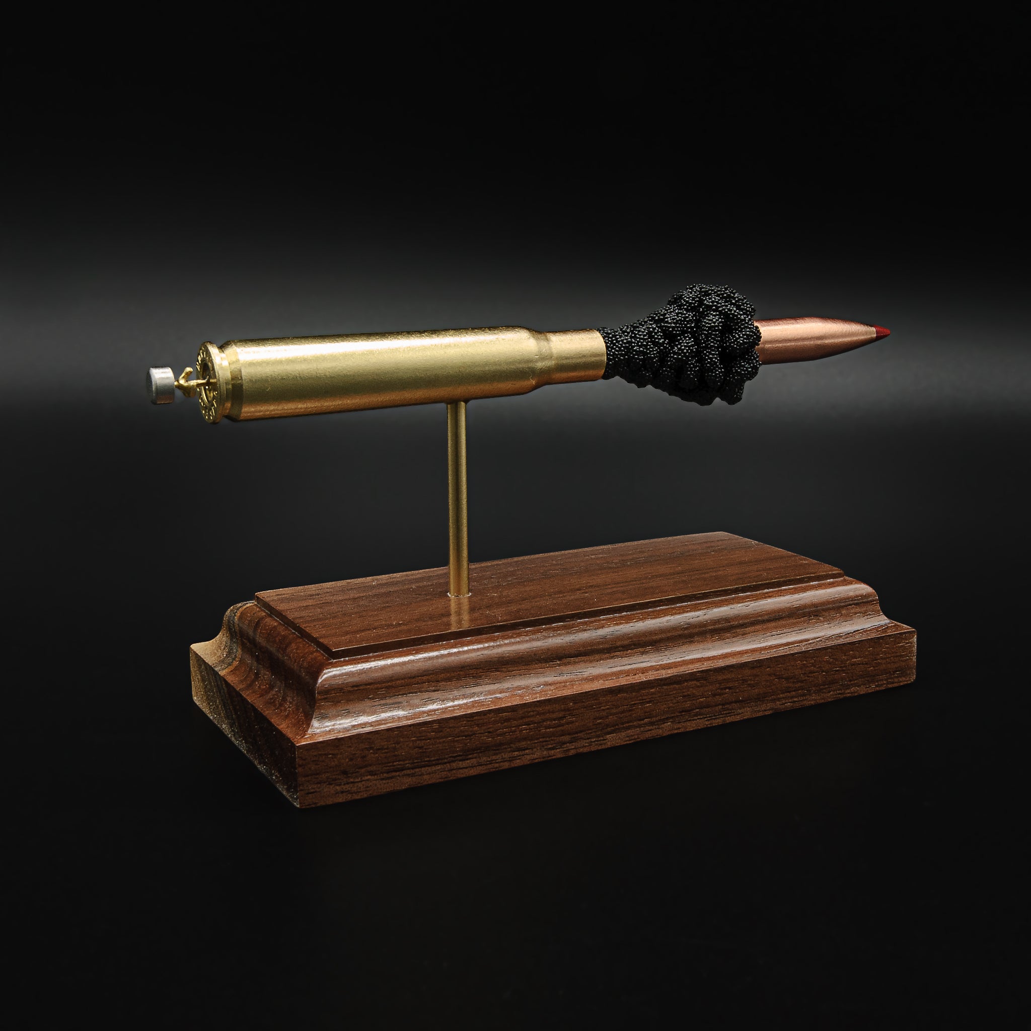 Side angle view of a .30-06 Springfield Hornady Precision Hunter 178gr ELD-X cartridge anatomy display with the primer cup, anvil, cartridge case, simulated powder, and projectile visible on a hardwood base.