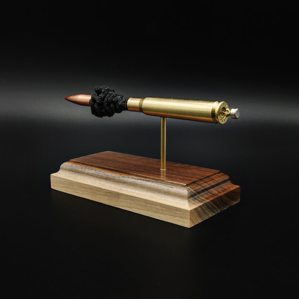 Rear view of a .30-06 Springfield Hornady Precision Hunter 178gr ELD-X cartridge anatomy display showing the cartridge case head, primer cup, anvil, simulated powder, and projectile on a hardwood base.