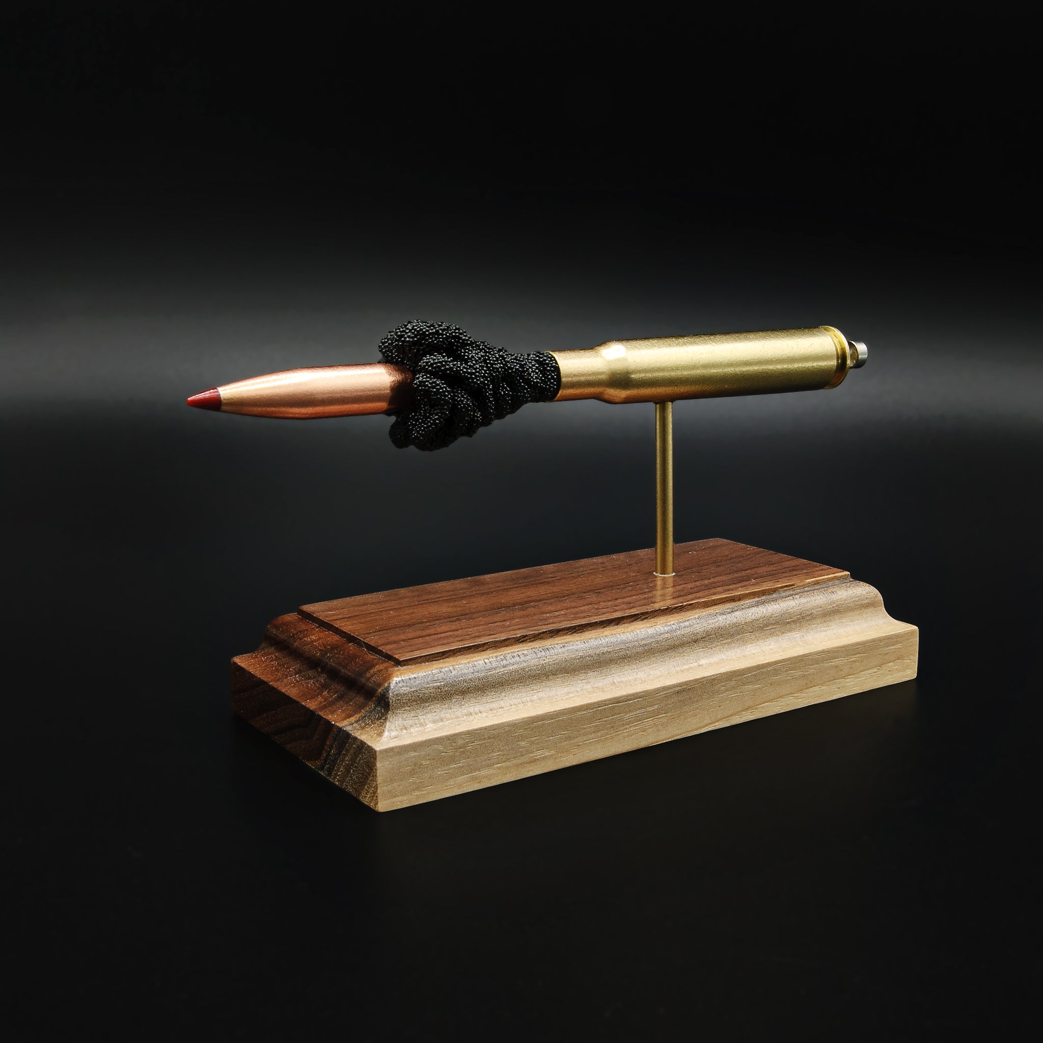 Angled front view of a .30-06 Springfield Hornady Precision Hunter 178gr ELD-X cartridge anatomy display featuring the primer cup, anvil, cartridge case, simulated powder, and projectile on a hardwood base.