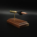 Close angled view of a .30-06 Springfield Hornady Precision Hunter 178gr ELD-X cartridge anatomy display highlighting the projectile, simulated powder, cartridge case, primer cup, and anvil on a hardwood base.