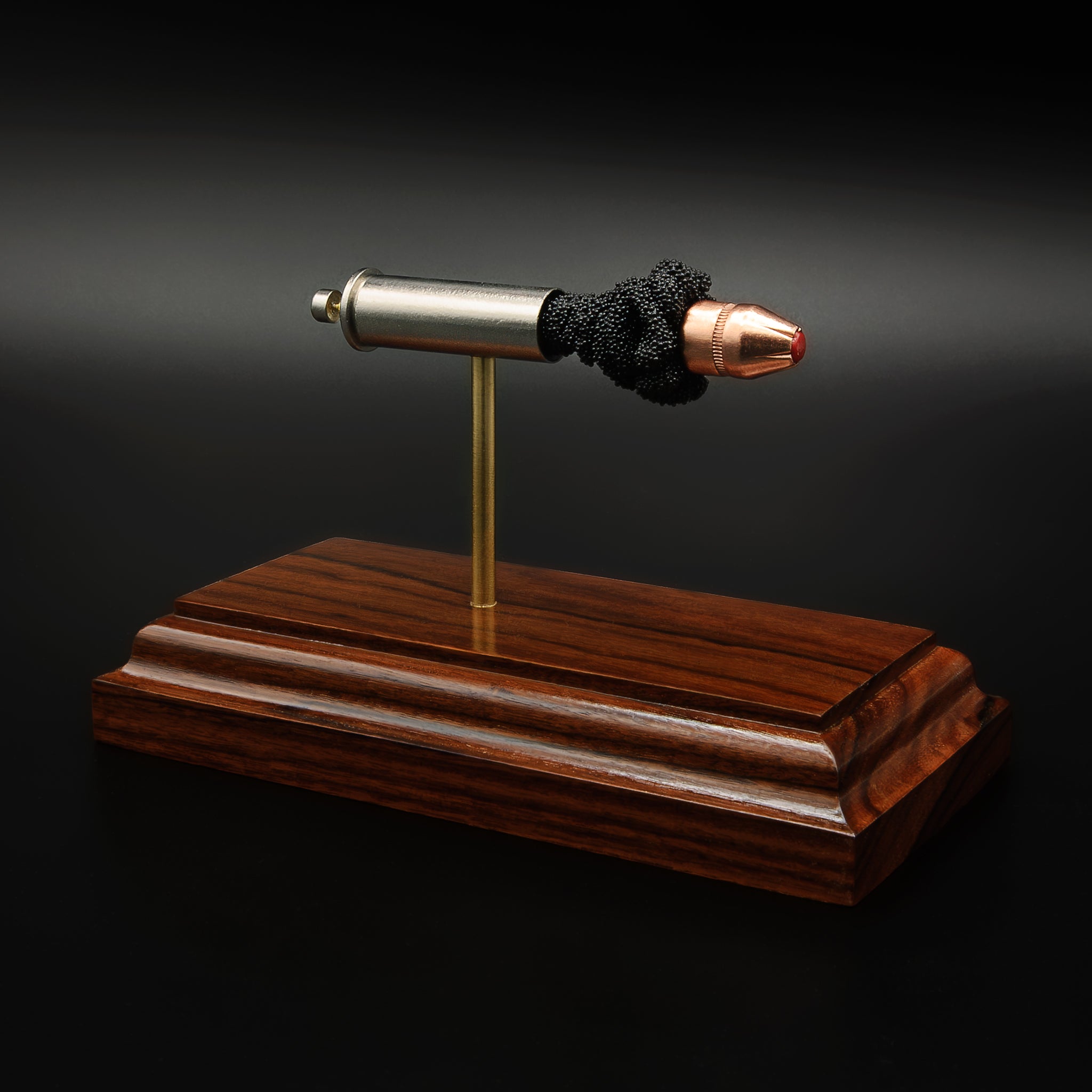 Angled view of .357 Magnum Critical Duty display with separated components mounted on rosewood base