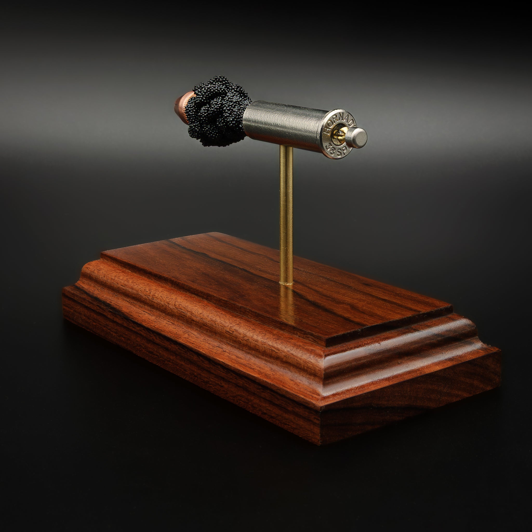 Back perspective of .357 Magnum Critical Duty model highlighting headstamp and component spacing on rosewood base