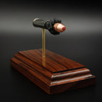 Front angled view of Critical Duty bullet in .357 Magnum exploded display on rosewood base