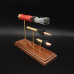 Full side view of a Heavy Metal 3-Gun anatomy model with the 12 gauge hull, wad and shot above expanded 308 Winchester and 45 Auto cartridges.