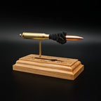 Front left angle of a .308 Winchester anatomy display showcasing a 168gr Sierra MatchKing HPBT bullet and engraved cartridge component diagram on a handcrafted cherry wood base.