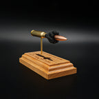 Left side view of a .308 Winchester cartridge display highlighting the 168gr Sierra MatchKing HPBT bullet, exposed cartridge components, and engraved anatomy diagram on a cherry wood base.