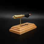 Rear three-quarter view of a .308 Winchester exploded cartridge display with a 168gr Sierra MatchKing HPBT bullet and engraved educational anatomy diagram on a premium cherry wood base.