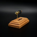 Rear view of a handcrafted 9mm Luger cartridge anatomy display featuring a 115gr Sierra FMJ bullet with an engraved anatomy diagram showing the primer cup, anvil, cartridge case, powder, and projectile that is mounted on a solid cherry wood base.