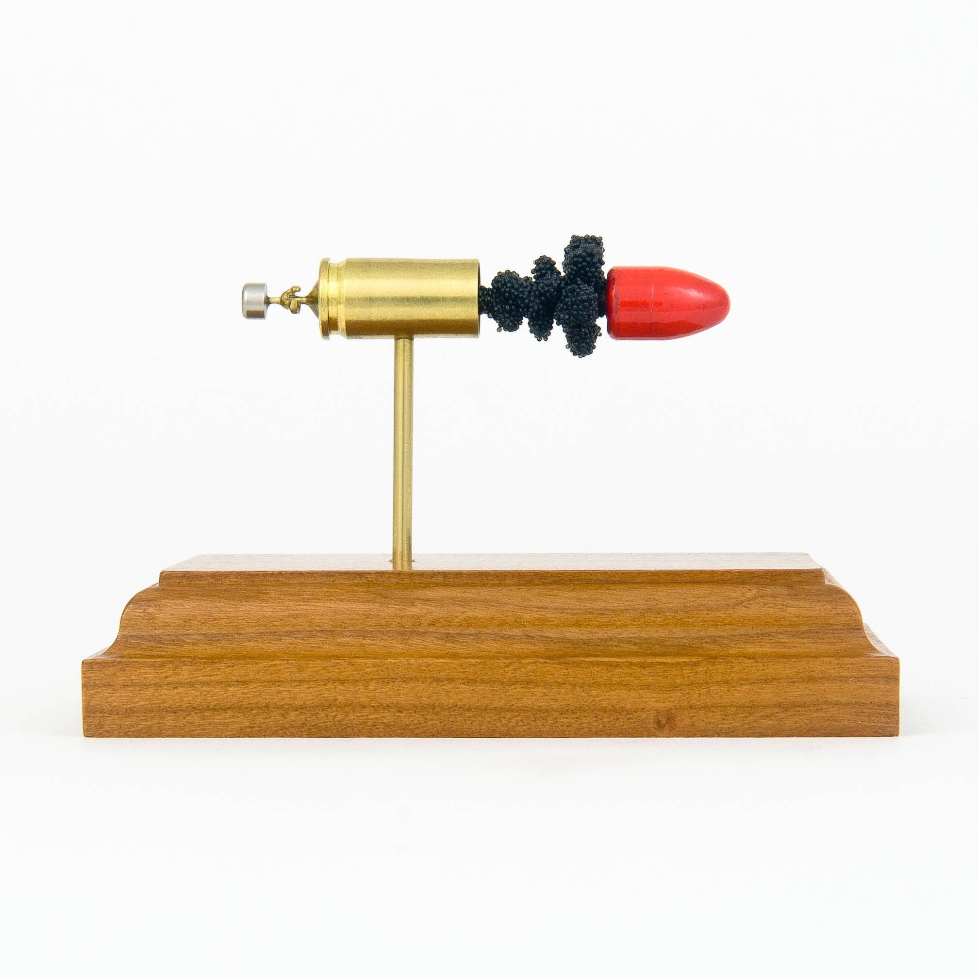 9mm Luger 115gr American Eagle Syntech TSJ expanded cartridge display on cherry hardwood base