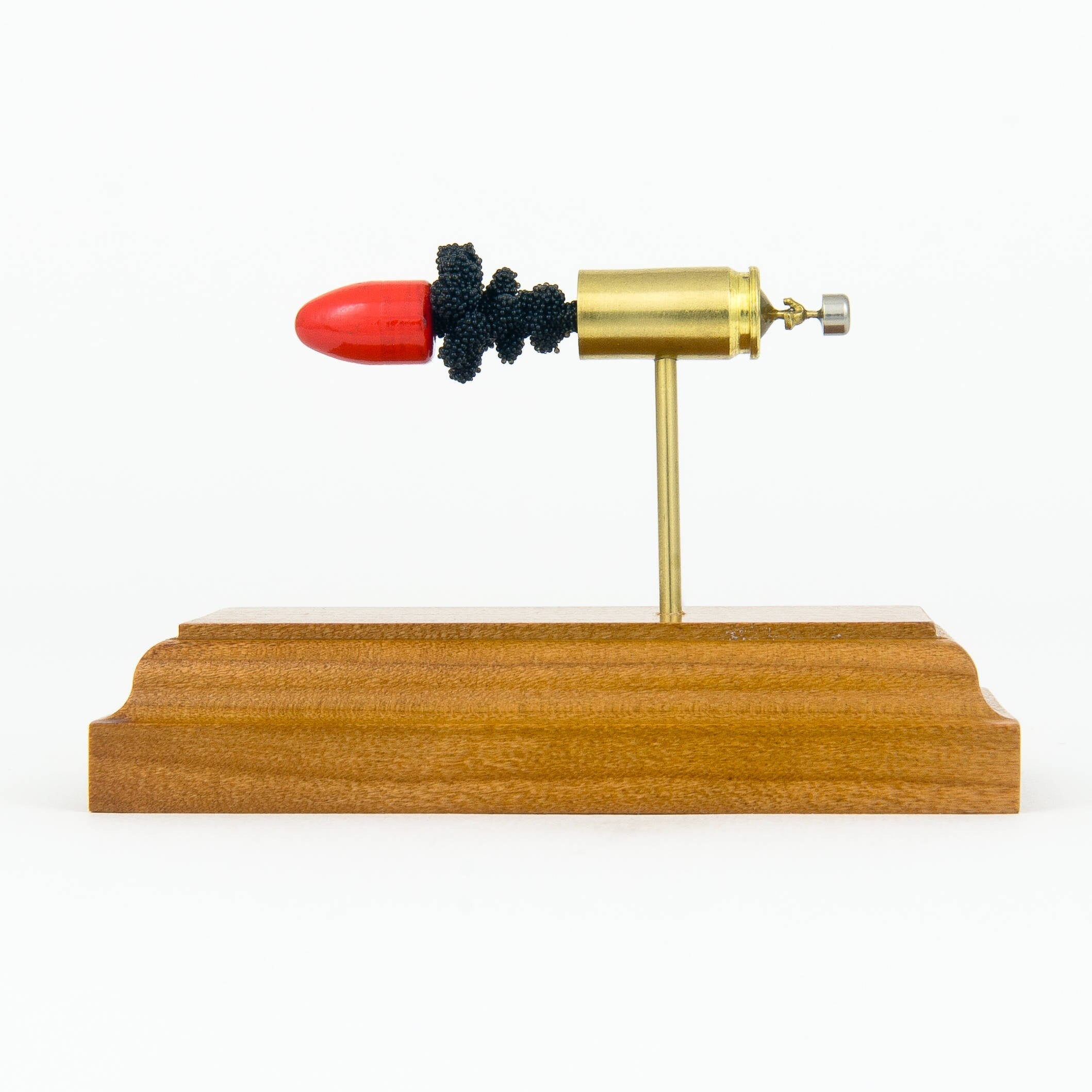 Handmade 9mm cartridge display aligned components mounted on solid wood base