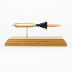 inert 338 win mag cartridge display on hardwood base