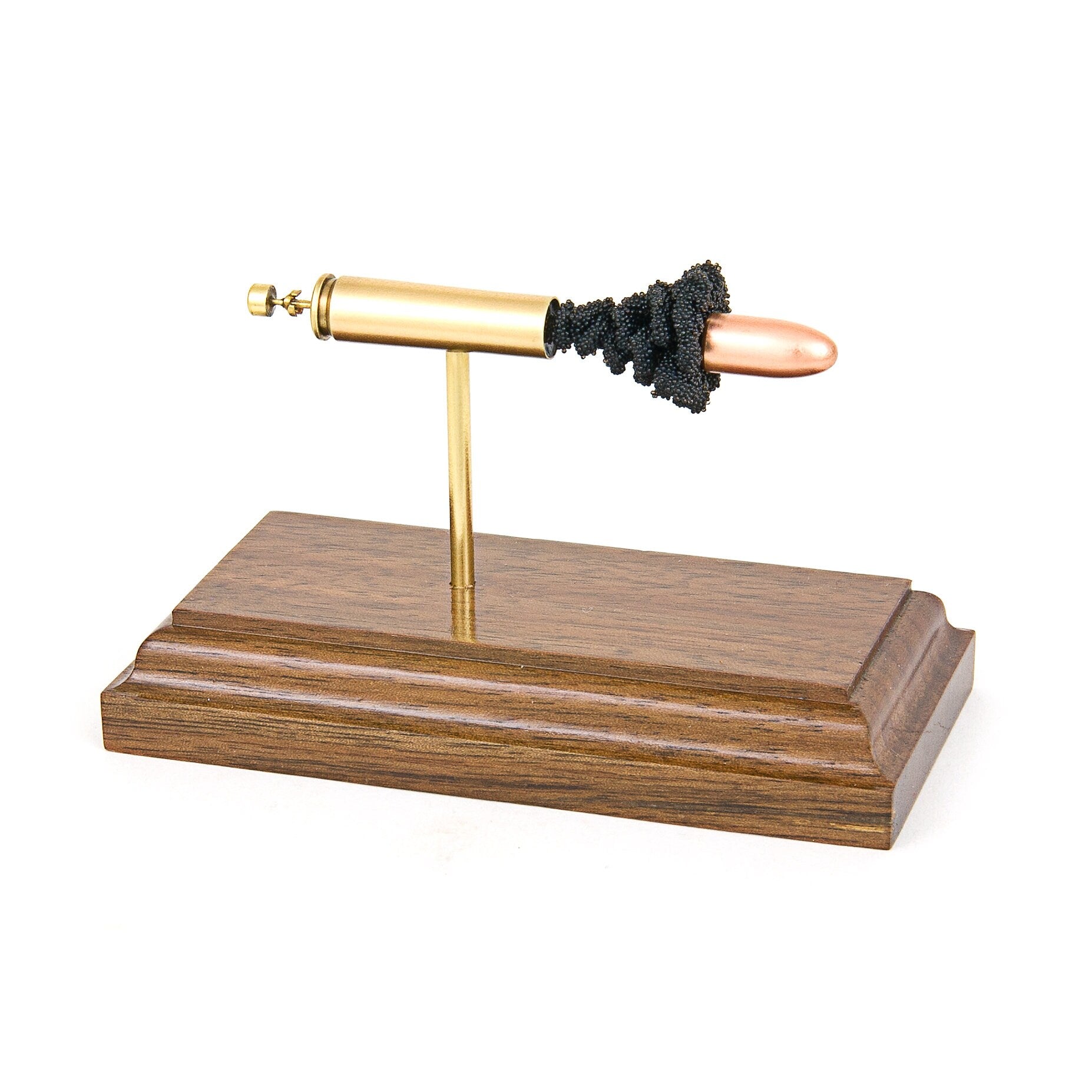 Expanded 30 Carbine cartridge display on hardwood base