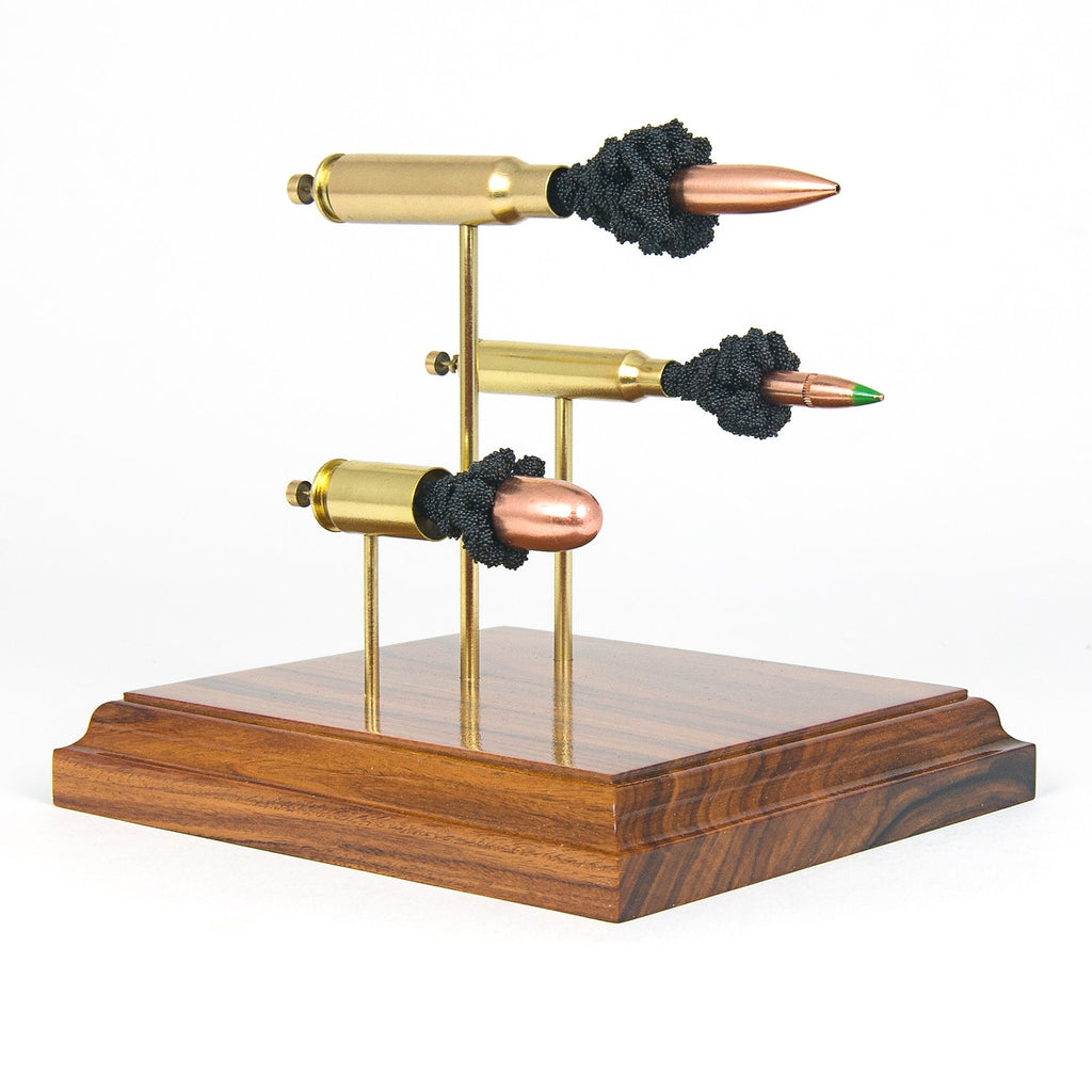 triple caliber inert cartridge display on hardwood base