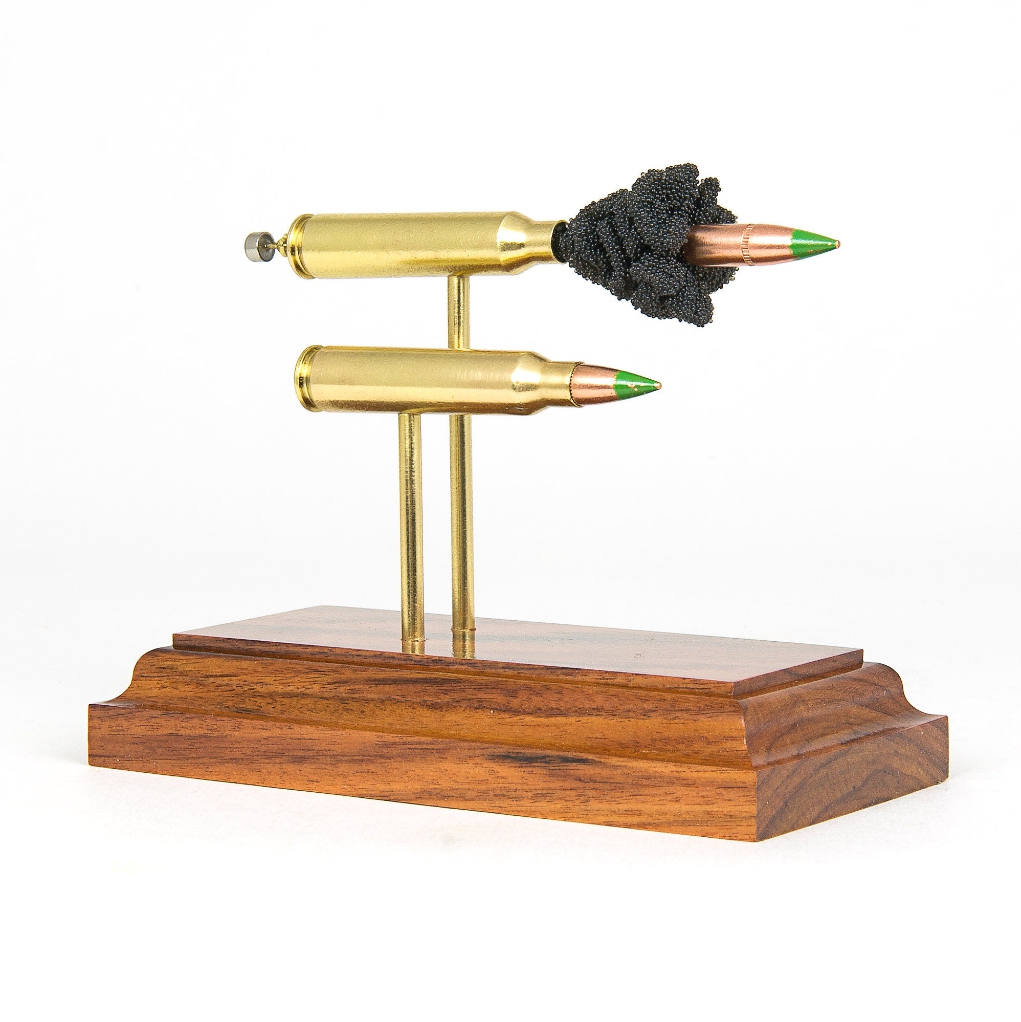 5.56x45 Green Tip Comparison Series dual cartridge display on hardwood base