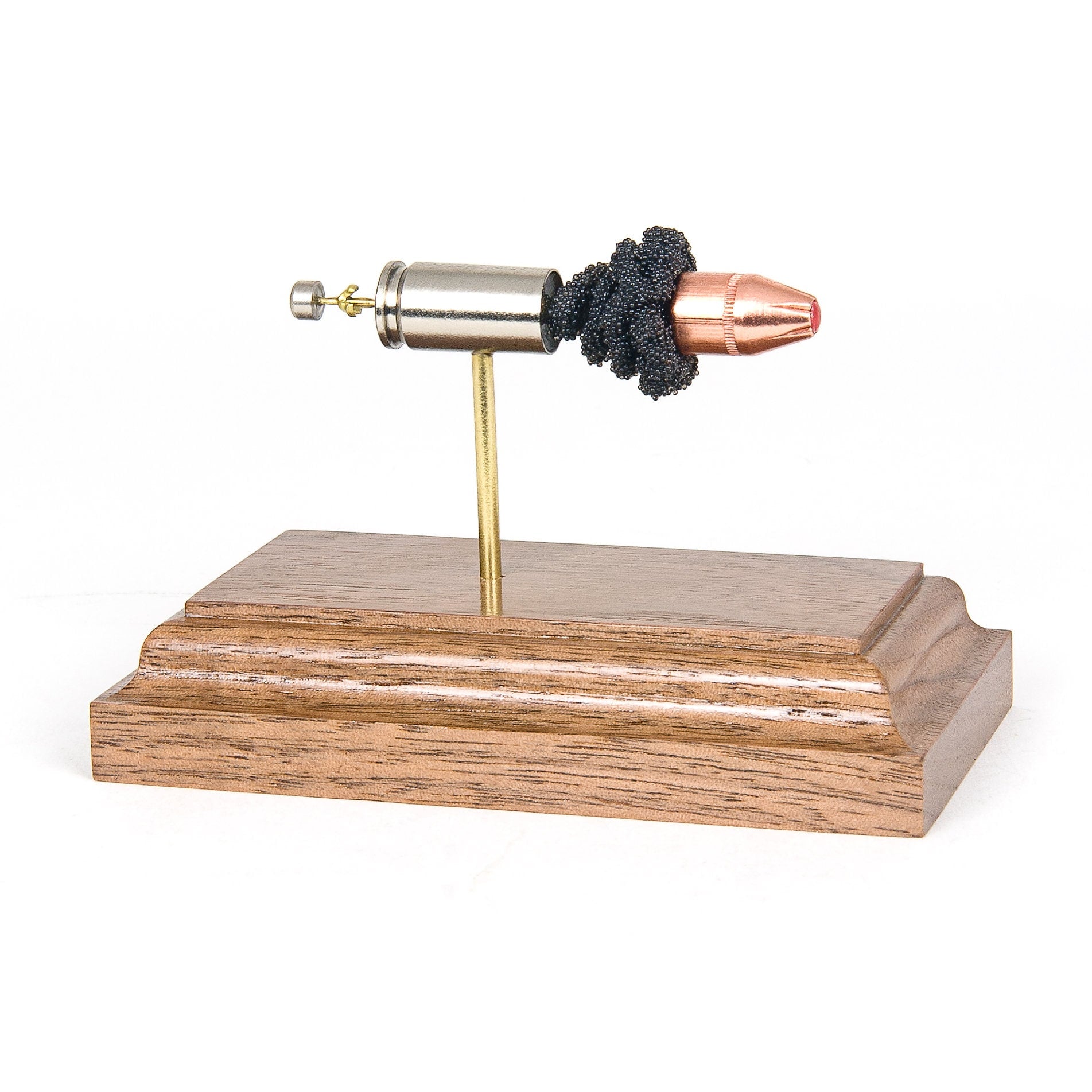 9mm Luger 115gr FTX Hornady Critical Defense expanded cartridge display on rosewood base