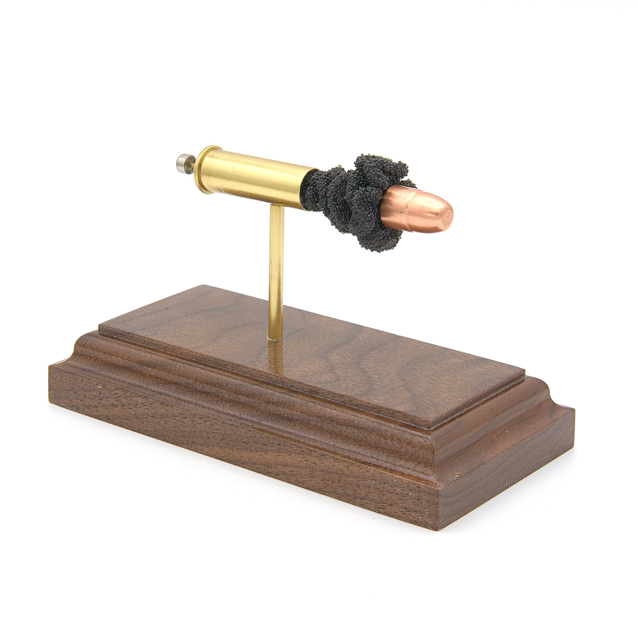 Expanded 38 Special copper FMJ cartridge display on hardwood base