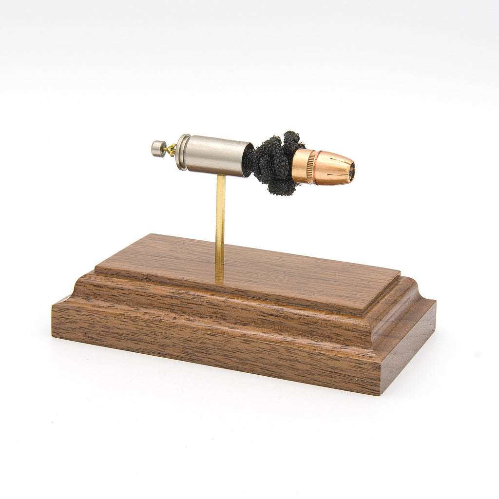 9mm Luger 124gr +P HST JHP Federal Premium expanded cartridge display on walnut base