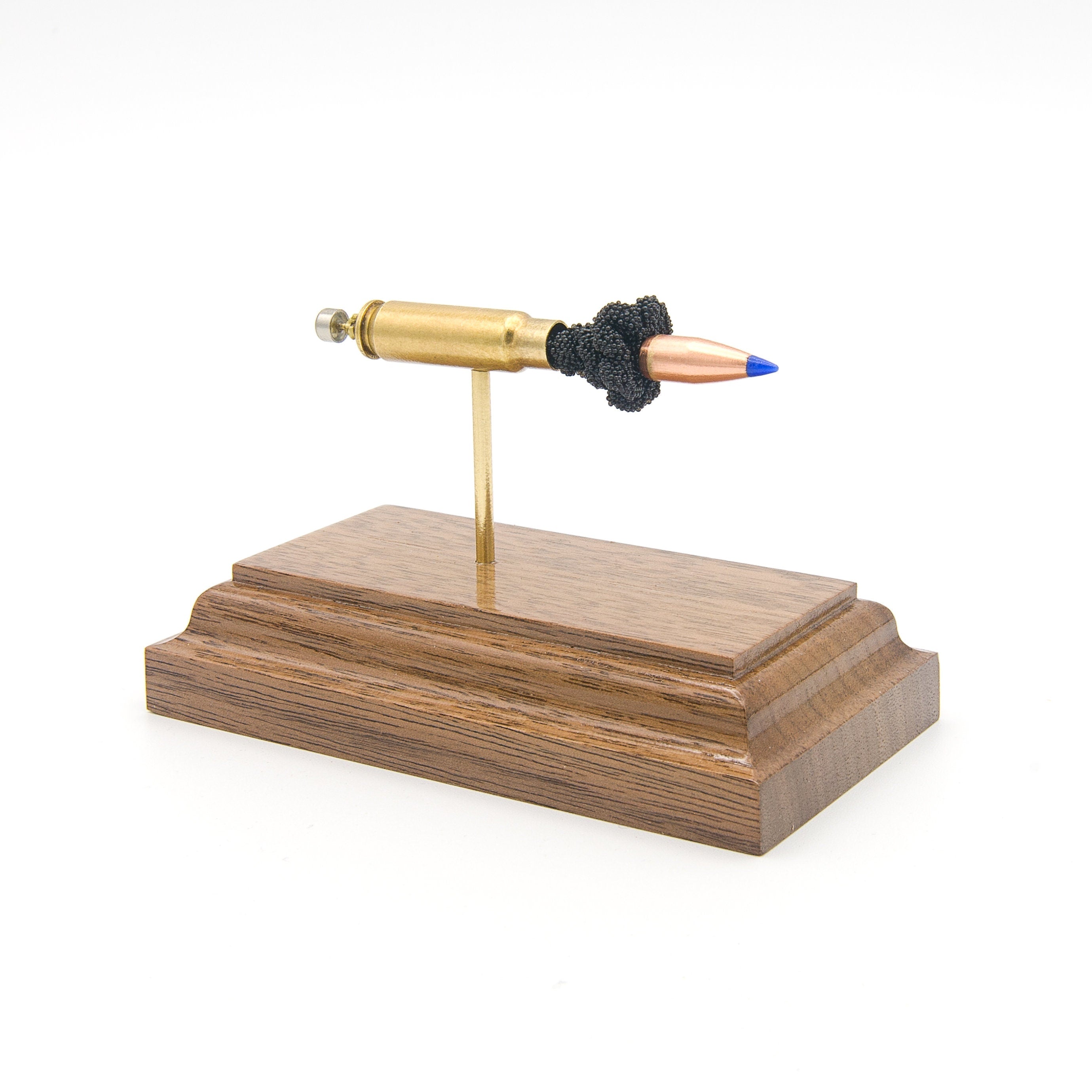 5.7x28mm FN SS197SR 40gr Hornady V-Max expanded cartridge display model on walnut base
