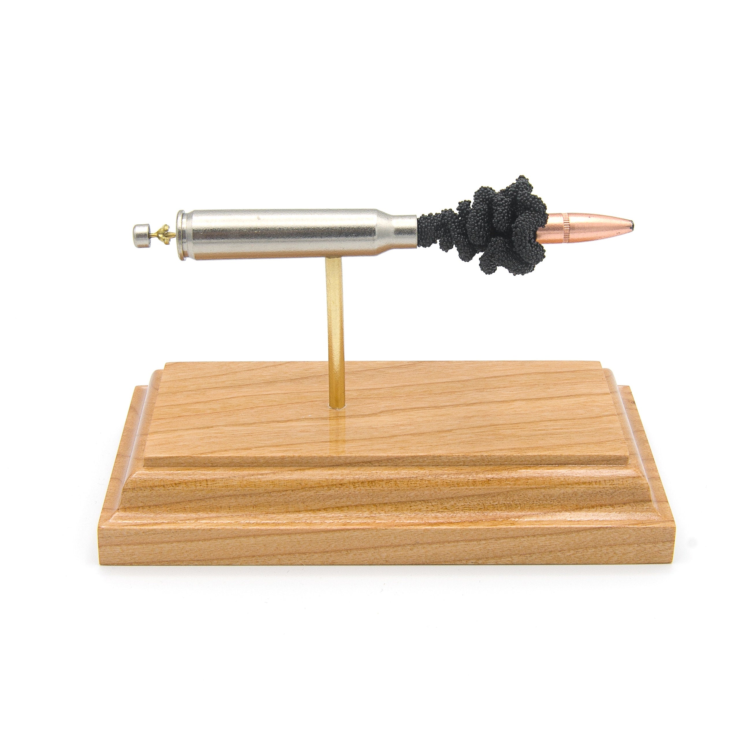 Expanded .223 Rem Speer Gold Dot cartridge display on cherry wood base