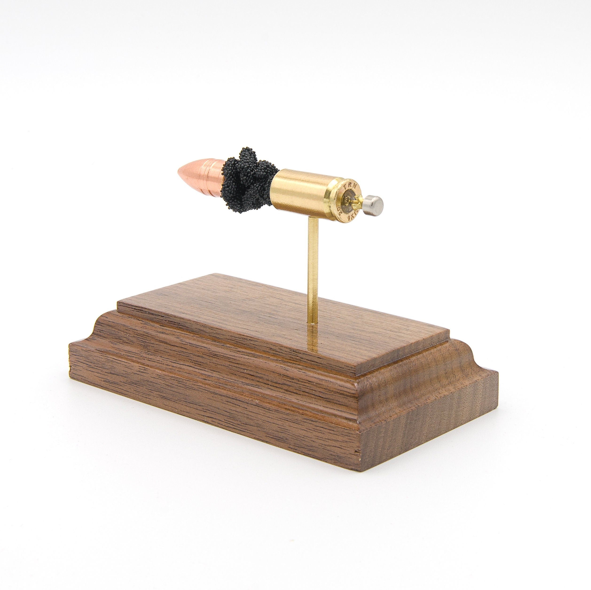 Handmade 9mm TUI cartridge display aligned on solid wood base