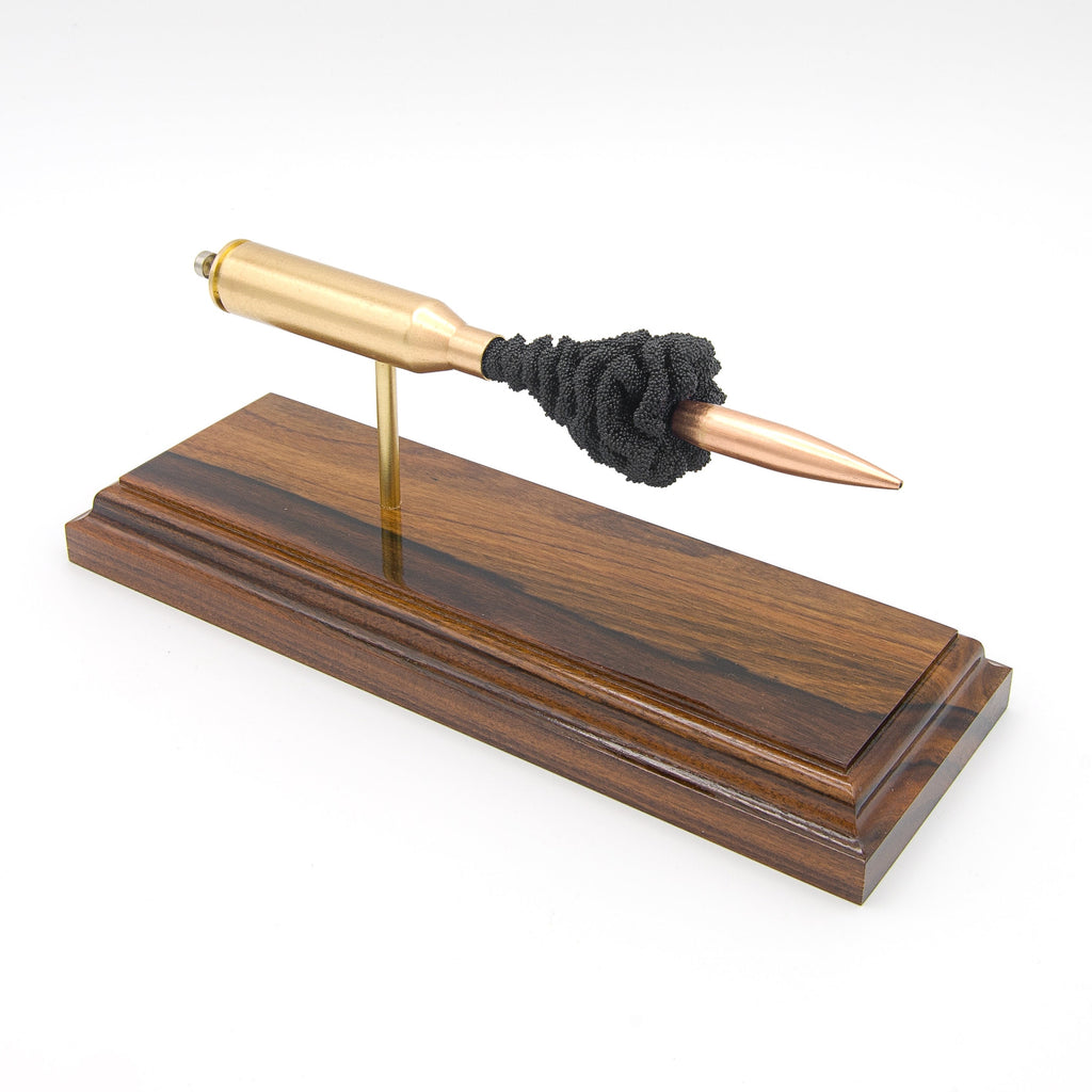 Expanded 300 Norma Magnum Berger 215gr cartridge display on hardwood base