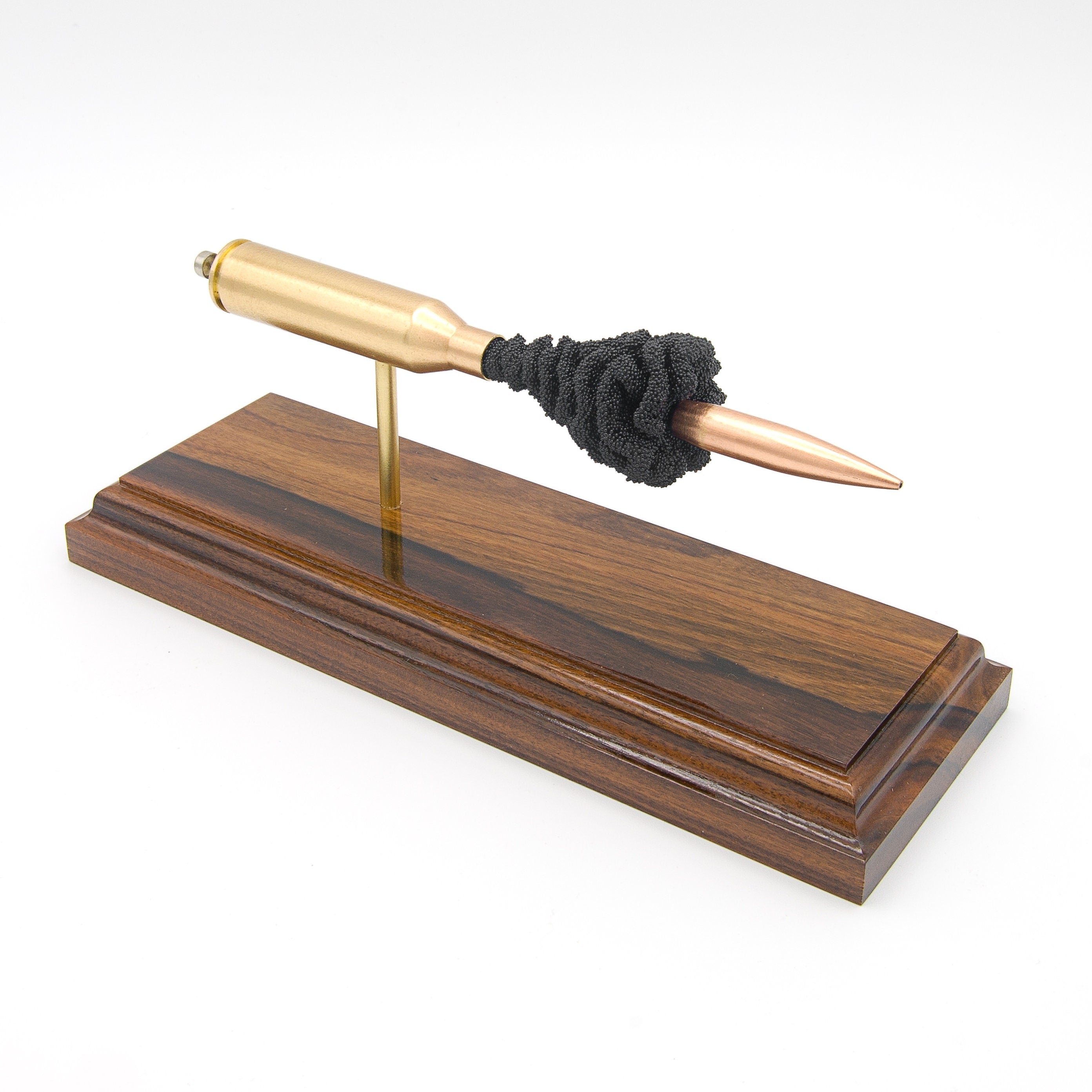 Expanded 300 Norma Magnum Berger 215gr cartridge display on hardwood base