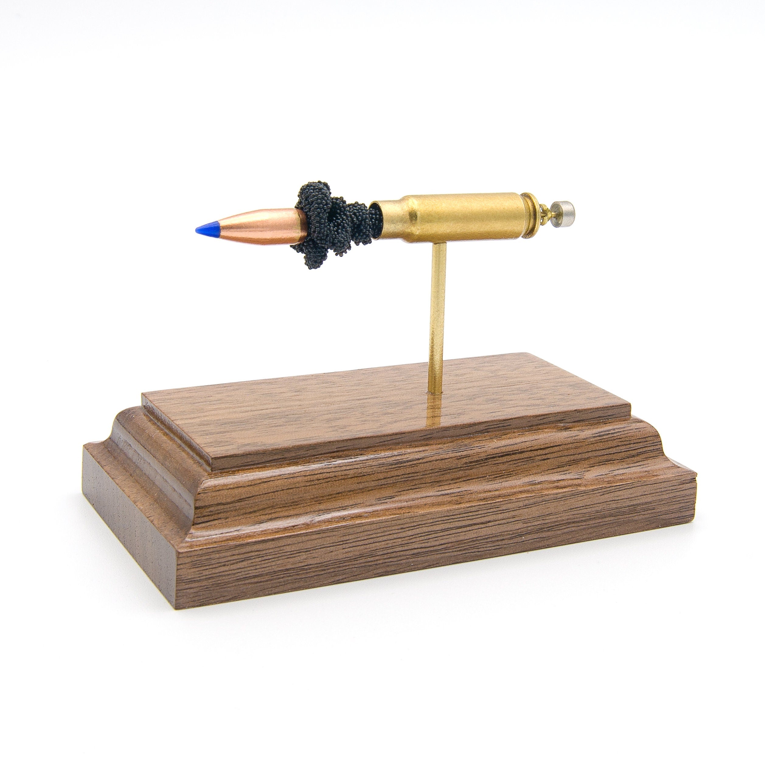 Sectioned 5.7x28mm cartridge showing primer case powder and 40gr V-Max bullet aligned horizontally