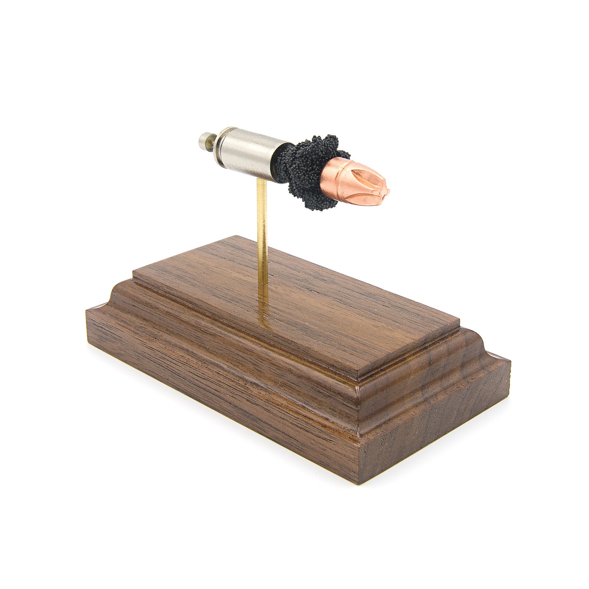 inert 9mm +p cartridge display on hardwood base