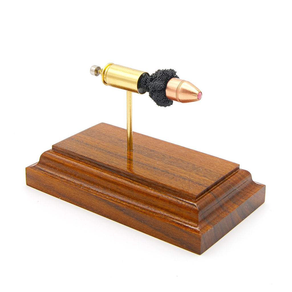 Expanded 9mm Luger Hornady Critical Defense Lite 100gr FTX cartridge display on hardwood base