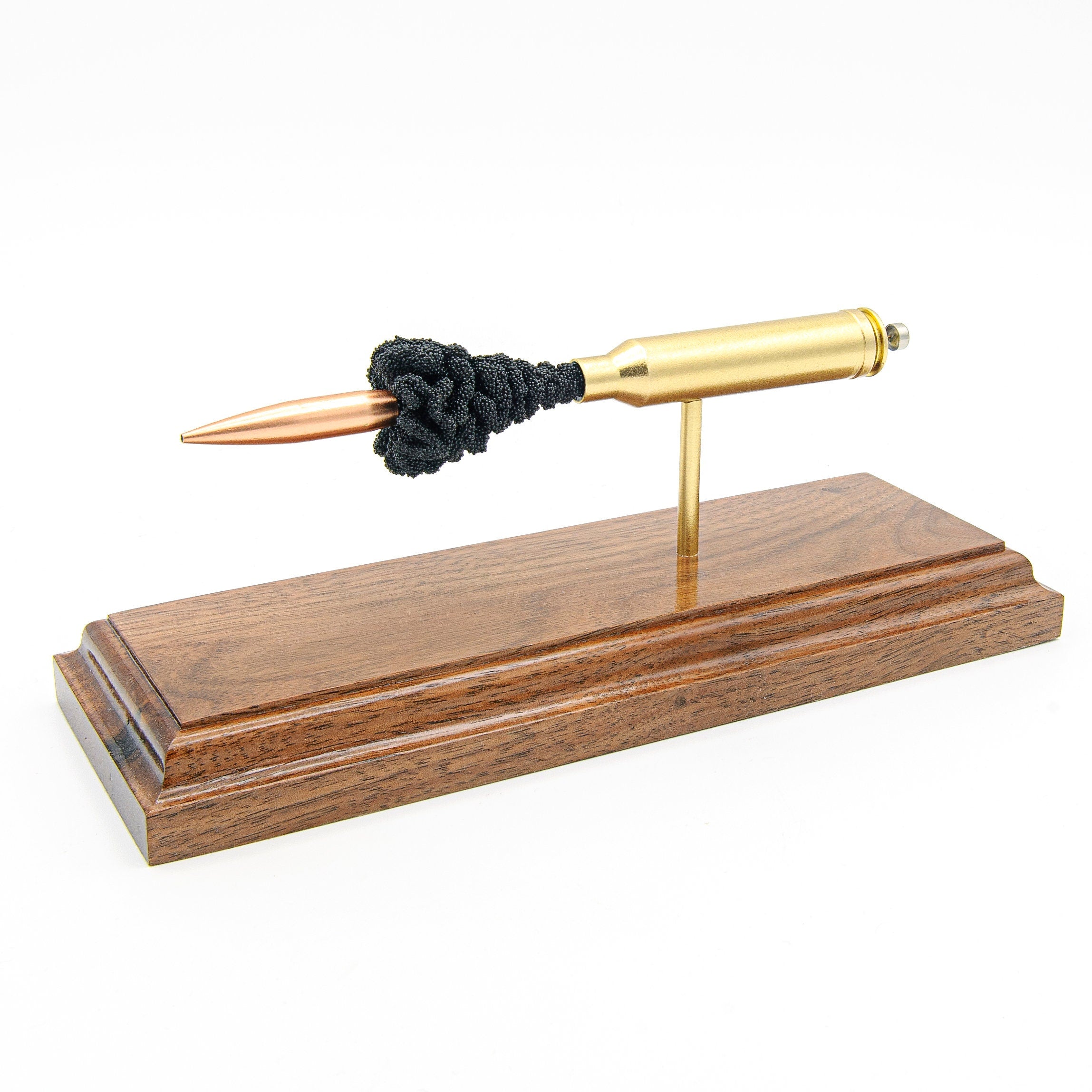 Handmade 7mm Rem Mag cartridge display aligned on solid wood base