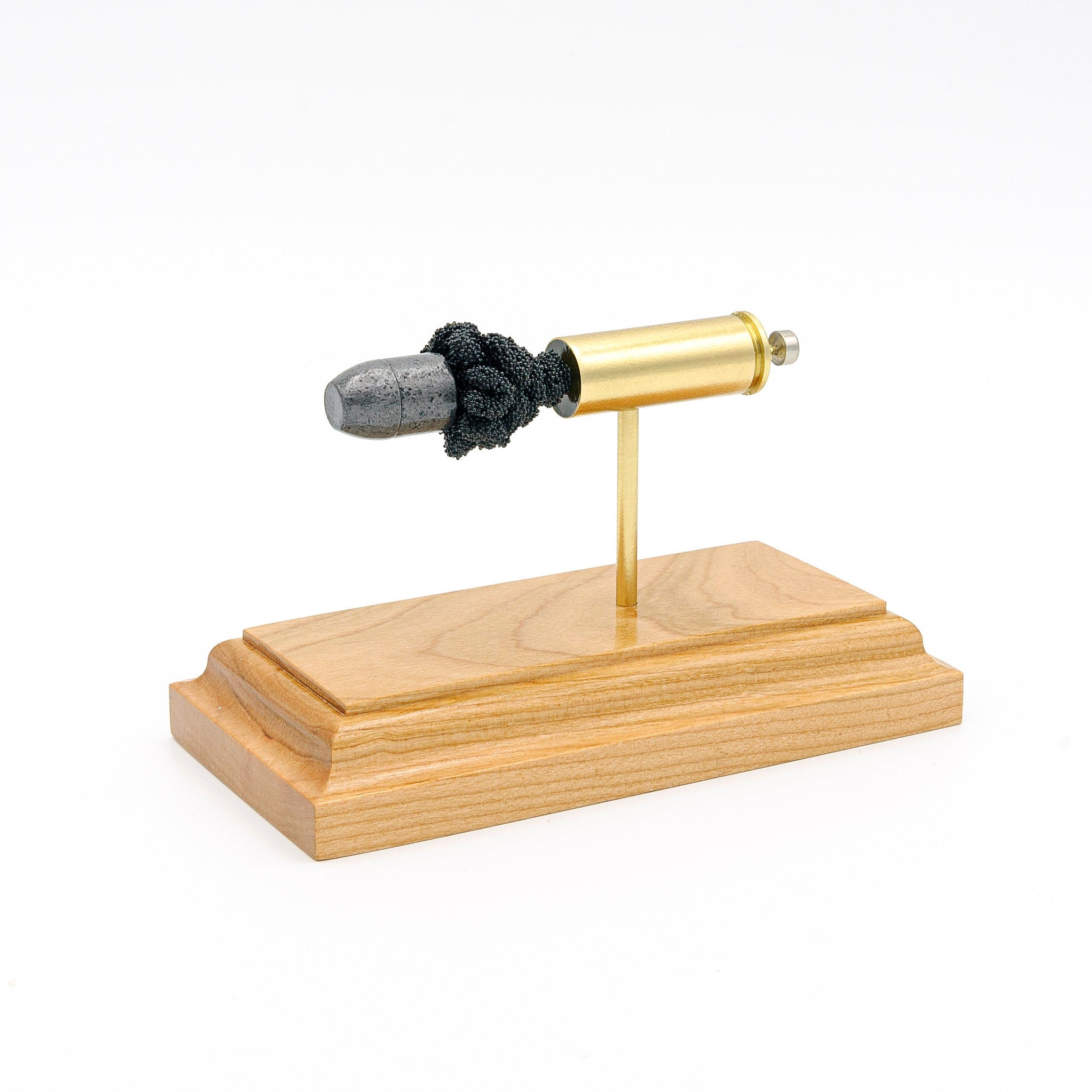 Sectioned 45 Colt revolver cartridge showing primer case powder and lead flat nose bullet aligned horizontally