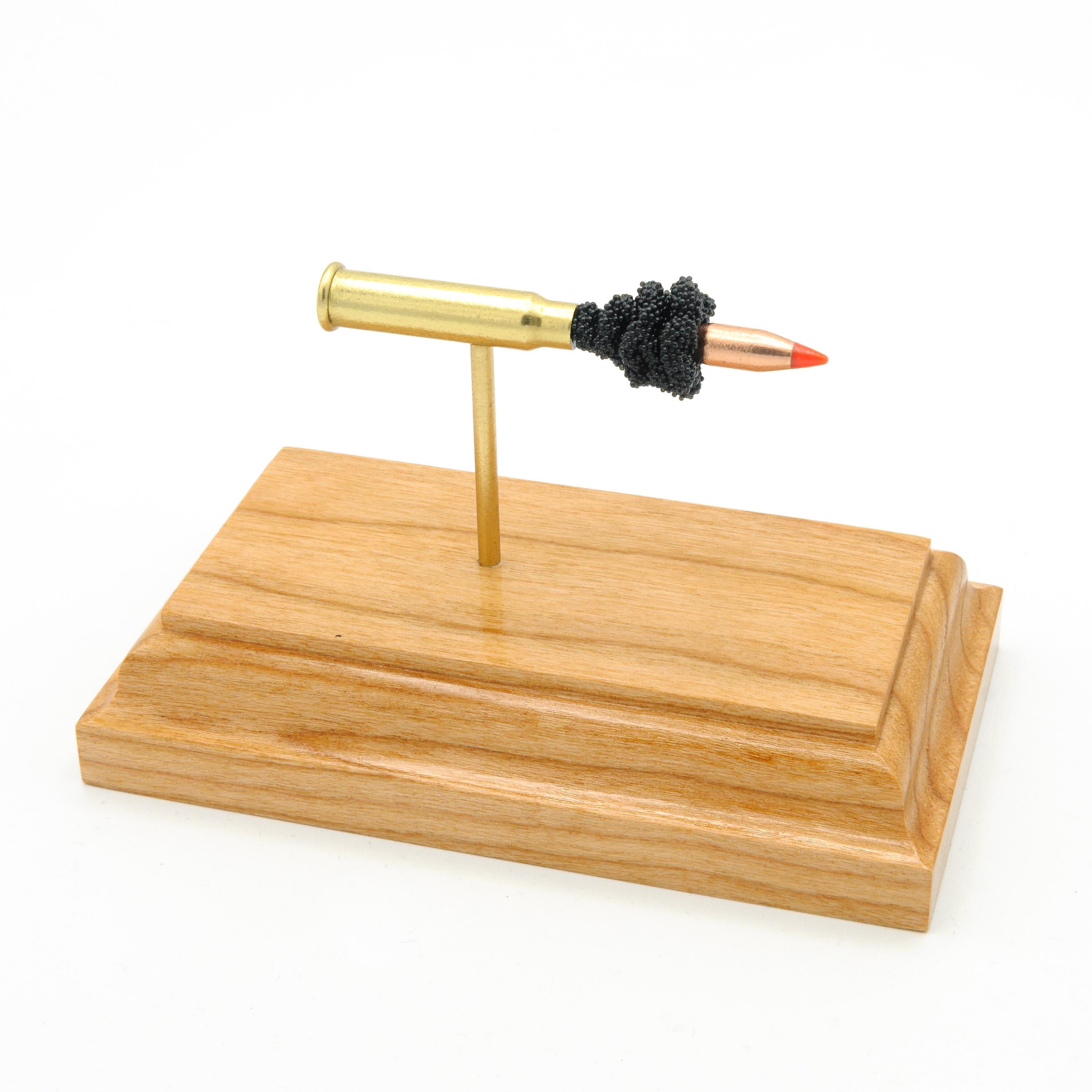 Expanded .17 HMR Hornady V-MAX cartridge display on walnut wood base