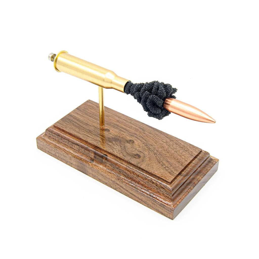 Expanded 7.62x54R cartridge display with brass case and 174gr HPBT bullet on hardwood base