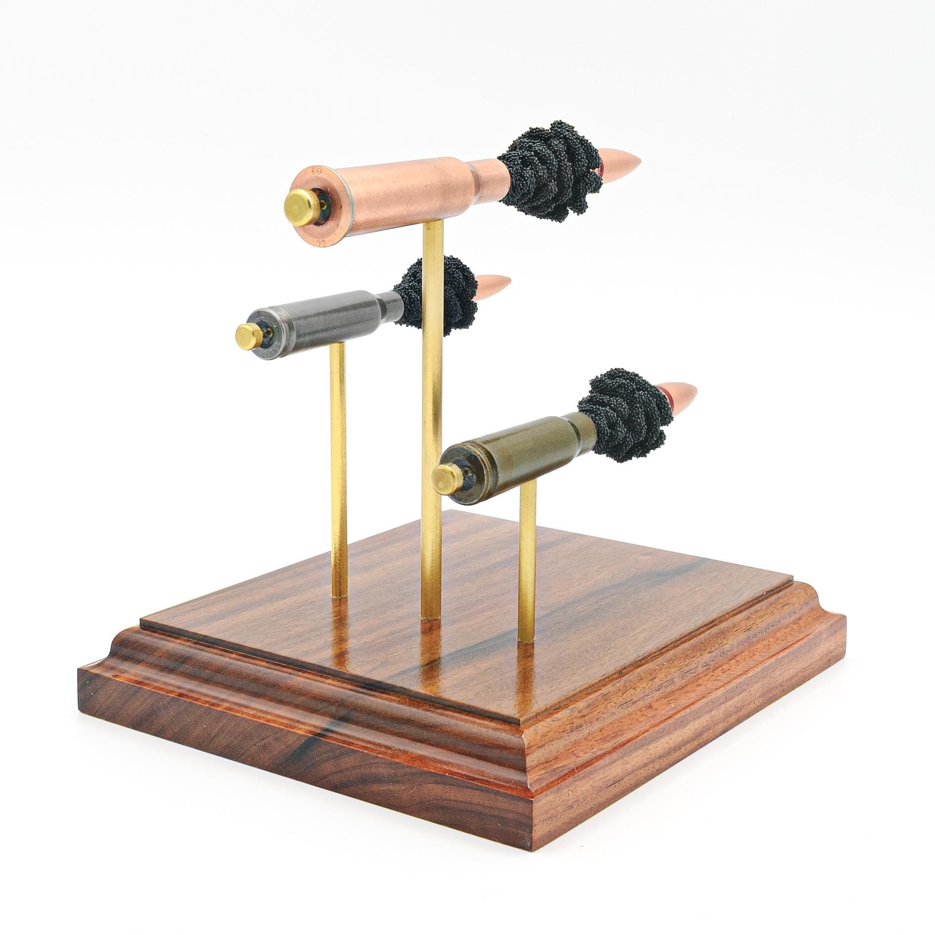 inert exploded ammunition display on hardwood base