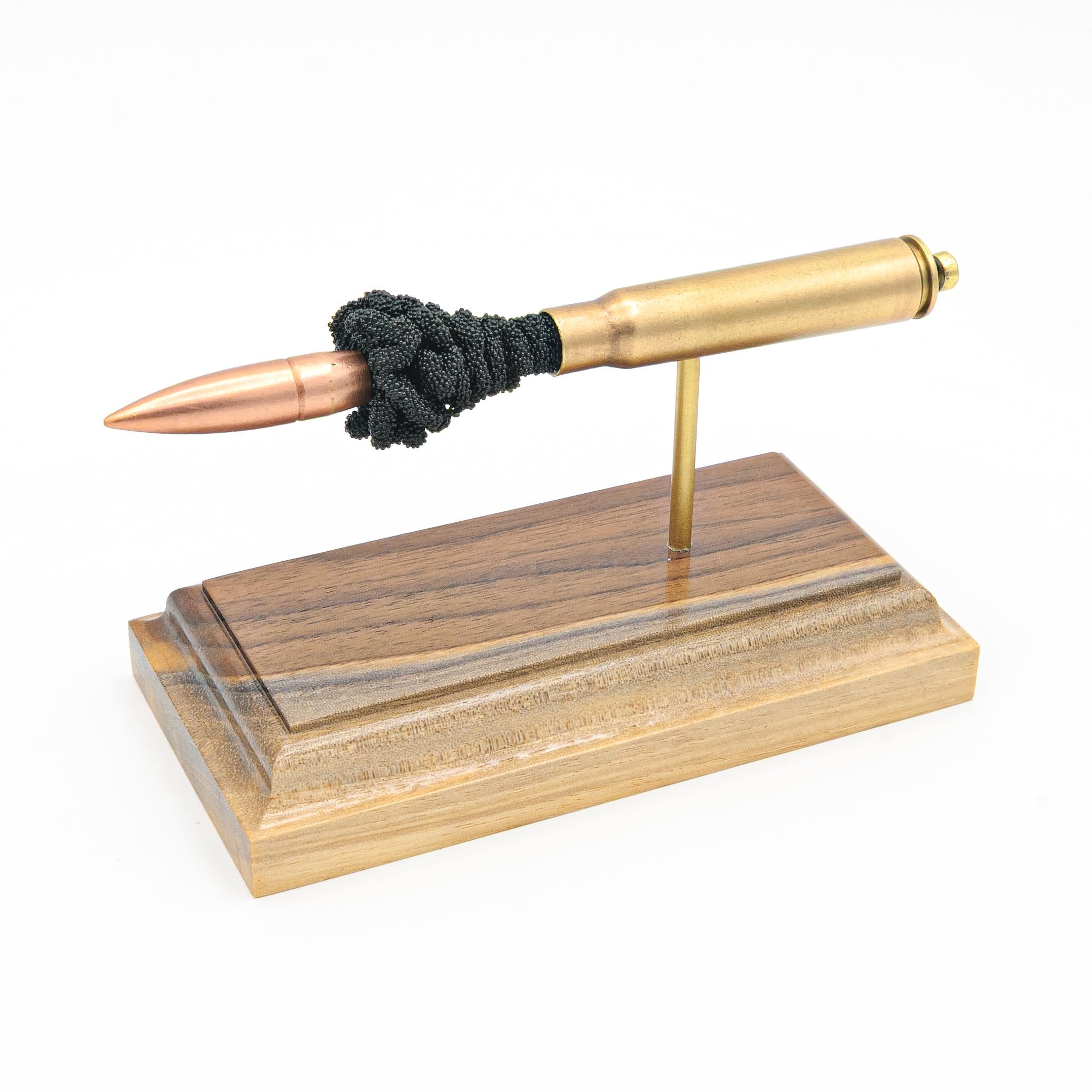 Handmade 8mm Mauser surplus cartridge display aligned on solid wood base