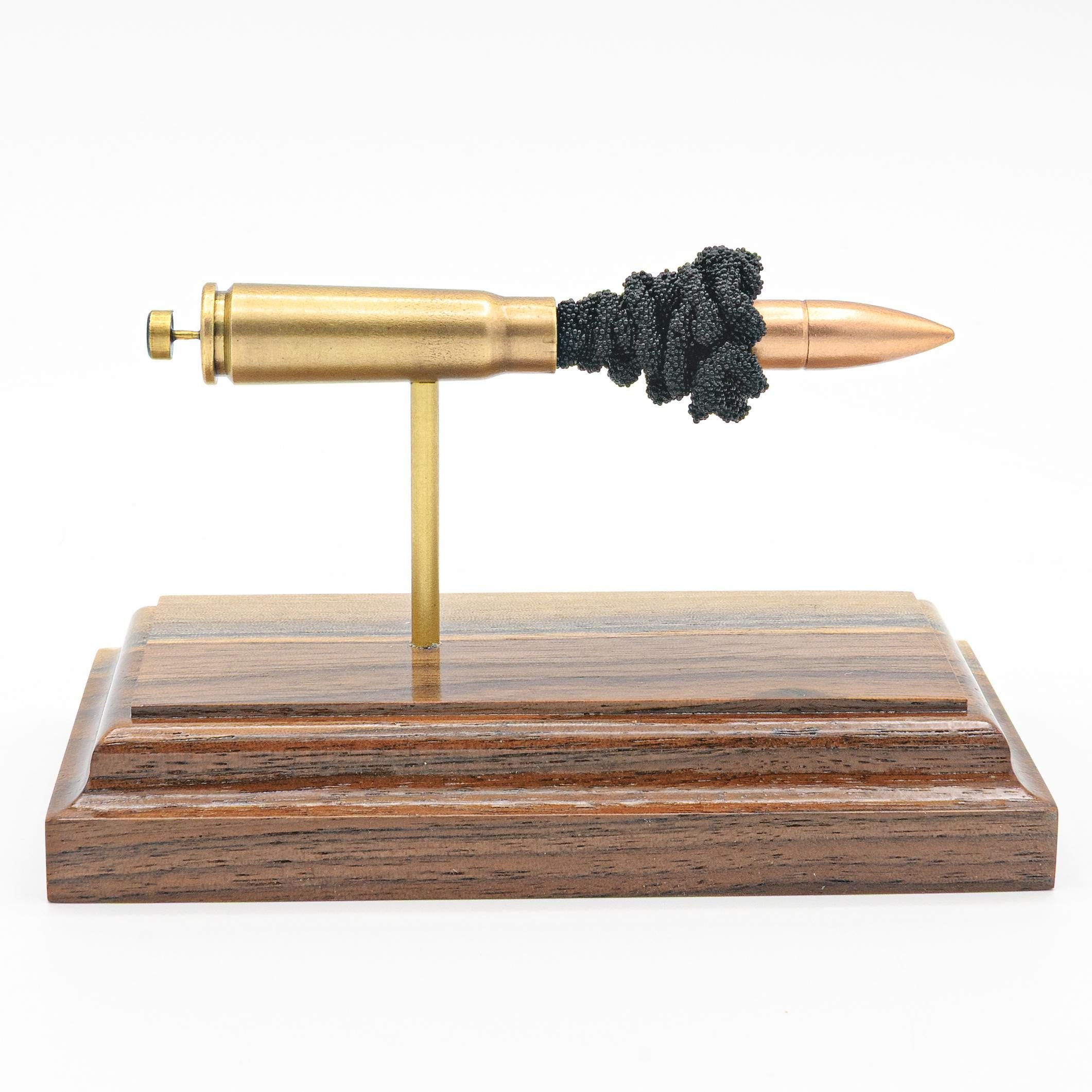 Expanded 7.62x39mm surplus AK cartridge display on hardwood base