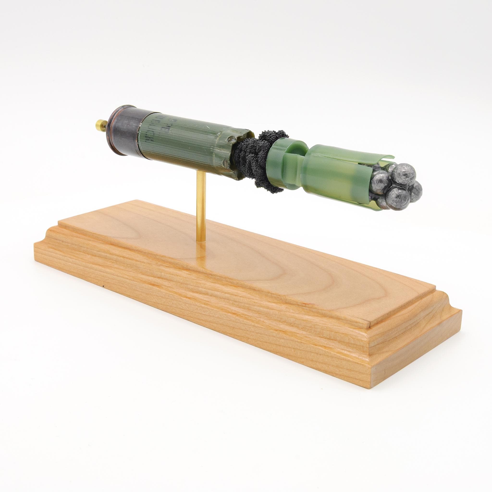 Expanded 12 gauge Winchester buckshot shotshell display on cherry wood base