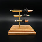 Side view of a handcrafted triple caliber exploded ammunition display featuring a .308 Winchester 168gr Sierra MatchKing HPBT, 5.56×45mm M855 Green Tip, and .45 Auto 220gr Sierra FMJ mounted on a premium cherry wood base.