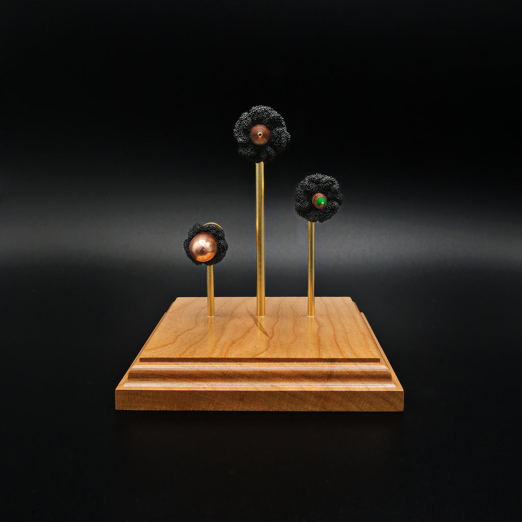 Bullet-forward view of a triple caliber exploded cartridge display highlighting the .308 Winchester 168gr Sierra MatchKing HPBT, 5.56×45mm M855 Green Tip, and .45 Auto 220gr Sierra FMJ on a handcrafted cherry wood base.