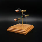 Front right perspective of a handcrafted triple caliber ammunition display featuring a .308 Winchester 168gr Sierra MatchKing HPBT, 5.56×45mm M855 Green Tip, and .45 Auto 220gr Sierra FMJ mounted on a cherry wood base.